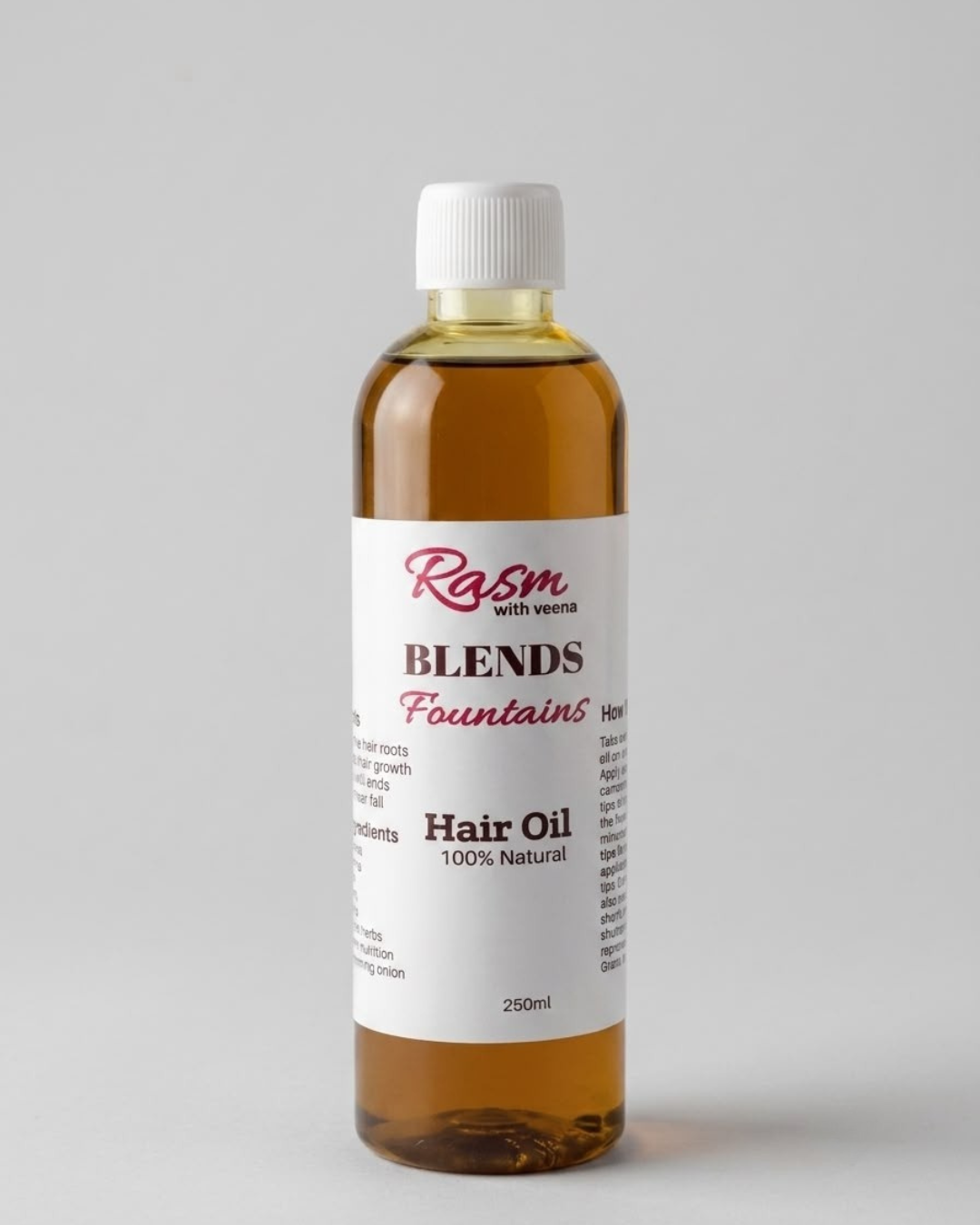 House of MKB Blends Fountains Intensive Herbal Hair Oil in a premium clear bottle displaying a rich golden amber color, surrounded by fresh raw amla and herbal ingredients.
