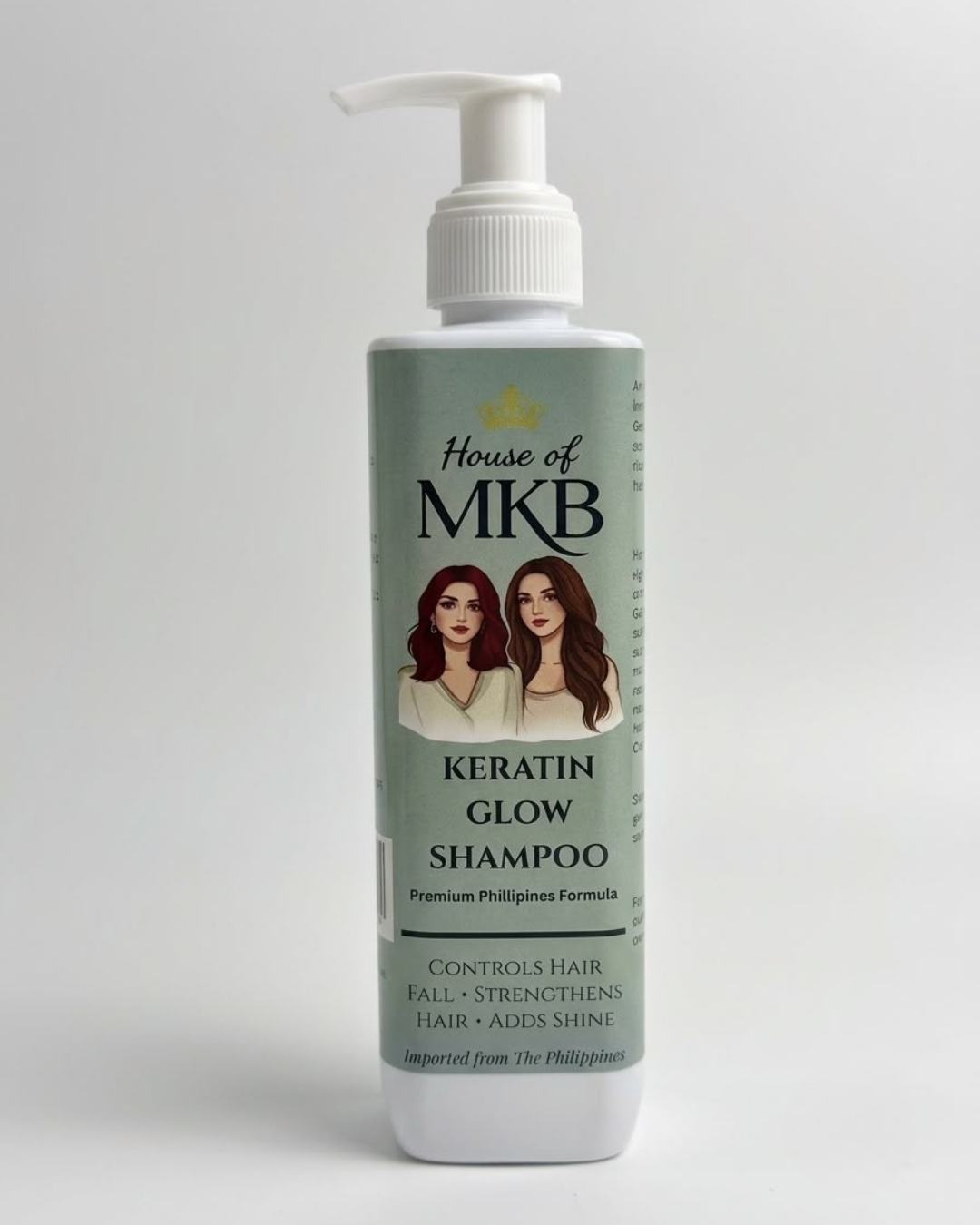 House of MKB Keratin Glow Shampoo bottle displayed on a luxury marble surface with green silk fabric background, gold comb, and raw argan oil ingredients.