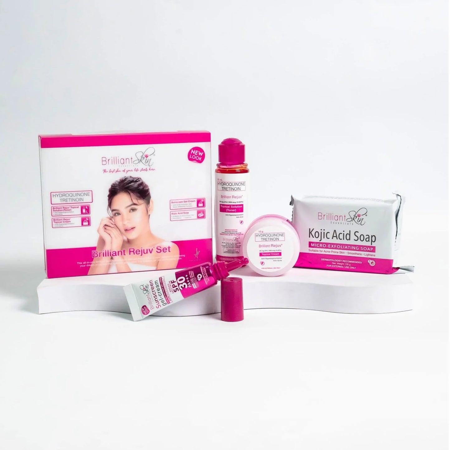 Full product contents of the Brilliant Skin Essentials Rejuvenating Facial Set including Kojic Acid Soap, Toner, Cream, and Sunscreen SPF 30.
