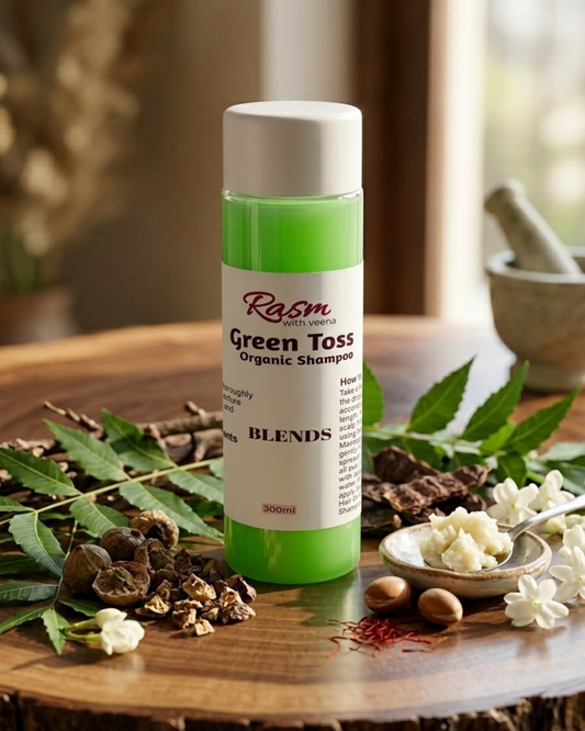 House of MKB Green Toss Organic Shampoo in a premium translucent bottle featuring a vibrant natural green color with rich organic herbs spread along the base.
